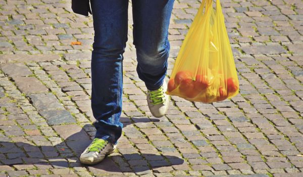 Person carrying plastic bag