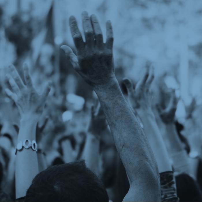 Close up image of people's hands raised at a rally